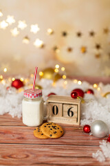 christmas background texture, christmas mood. A glass of milk with gingerbread cookies and candies. Christmas gingerbread. gingerbread with milk. new year lollipop. Calendar with date 6 January