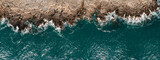 Fototapeta Do pokoju - Wild ocean waters from above, waves hitting rocks - aerial photography.