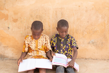 two young african kids studying together