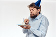 © SHOTPRIME STUDIO - Happy guy with birthday cake white background Compact corporate party cropped beard view