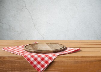 Wall Mural - Wooden cutting board and tablecloth on wooden table