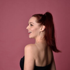 Sticker - Close up portrait of a red haired woman with expressive facial features on a pink studio background.