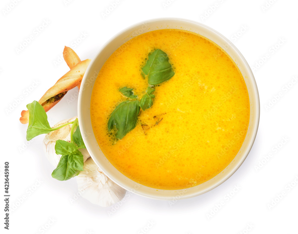 Bowl with tasty garlic cream soup on white background