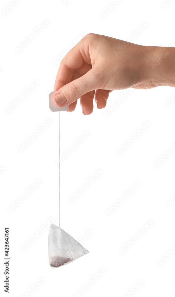 Female hand with tea bag on white background