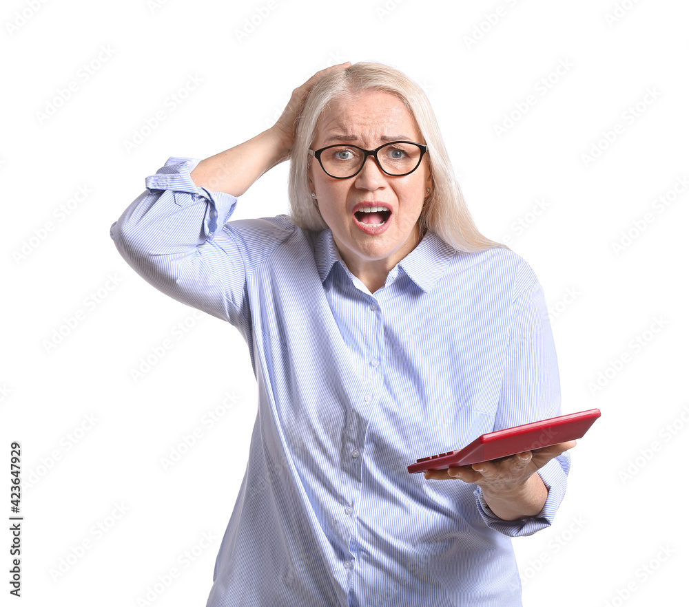 Stressed mature woman with calculator on white background