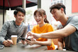 © imtmphoto - young asian adults looking at cellphone