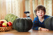 © alexkich - Little child choose a pumpkin at autumn. Child sitting on giant pumpkin. Pumpkin is traditional vegetable used on American holidays - Halloween and Thanksgiving Day.