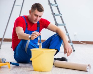 Wall Mural - Male painter preparing for painting job at construction site