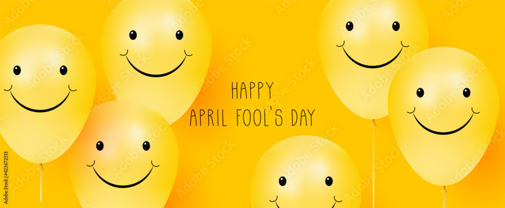 Happy April Fool's day. Yellow background with smiling balloons. Positive emotions - obrazy, fototapety, plakaty 