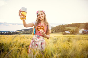 Wall Mural - Happy Bavarian woman with beer and traditional food in summer