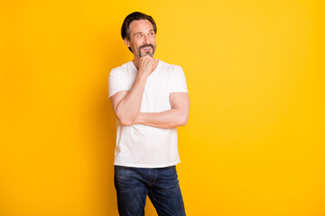 Poster - Portrait of attractive cheerful guy wearing casual creating solution isolated over bright yellow color background