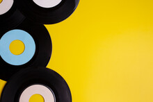 Old Vinyl 45 Rpm Records On Yellow Background