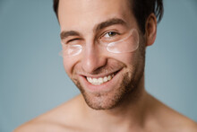 Shirtless White Man With Under Eye Patches Winking At Camera