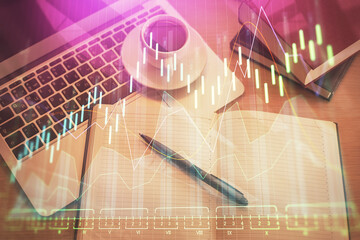 Stock market graph and top view computer on the table background. Multi exposure. Concept of financial education.