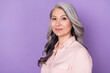 © deagreez - Profile side view portrait of attractive content wise grey-haired woman granny wearing pink shirt isolated over violet purple color background