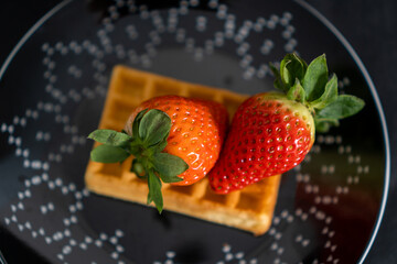 Wall Mural - waffle with strawberries on a black plate