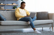 © Prostock-studio - Black guy spending time at home, using laptop