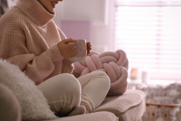 Sticker - Woman with cup of drink relaxing at home, closeup. Cozy atmosphere