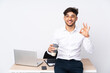 © luismolinero - Arabian man in a office isolated on white background showing ok sign with fingers