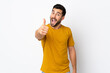© luismolinero - Young handsome man with beard isolated on white background with thumbs up because something good has happened