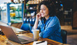 © BullRun - Happy Caucaisan woman 20s watching positive movie video during leisure in coffee shop, cheerful hipster girl smiling while reading received email message or funny publication in social media