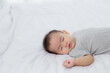 © N_studio - Portrait of asian little baby girl sleeping on bed in the bedroom at home, newborn napping with cozy and relax, infant innocence in bedtime, happy toddler cute, growth of child and emotion, indoors.