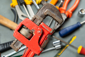 Griffin wrench isolated on blurred background with a variety of tools