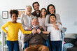 Extended happy family Generations portrait at home with handicapped senior