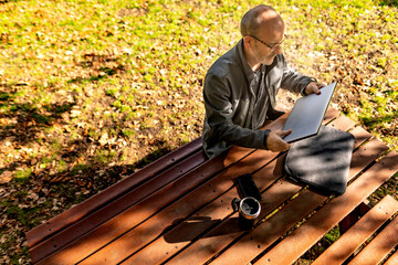Man setting up to work on picnic table in park
