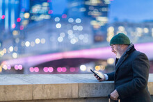 Man In City, Looking At Phone, London, UK