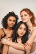 © Ivan - Photo of optimistic cute women, multiracial friends, wear underwear. Feminist females hug each other and show their love. Concept natural beauty and girl power
