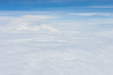 Wall Mural - over the clouds,Blue sky with tiny clouds background Beautiful natural view from airplane window above. Background or Wallpaper.blue sky and cloud sky nature.Top view of aircraft