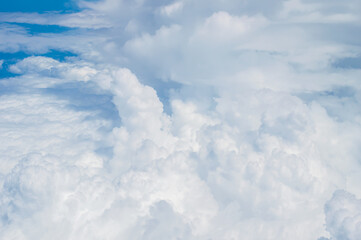 Wall Mural - over the clouds,Blue sky with tiny clouds background Beautiful natural view from airplane window above. Background or Wallpaper.blue sky and cloud sky nature.Top view of aircraft