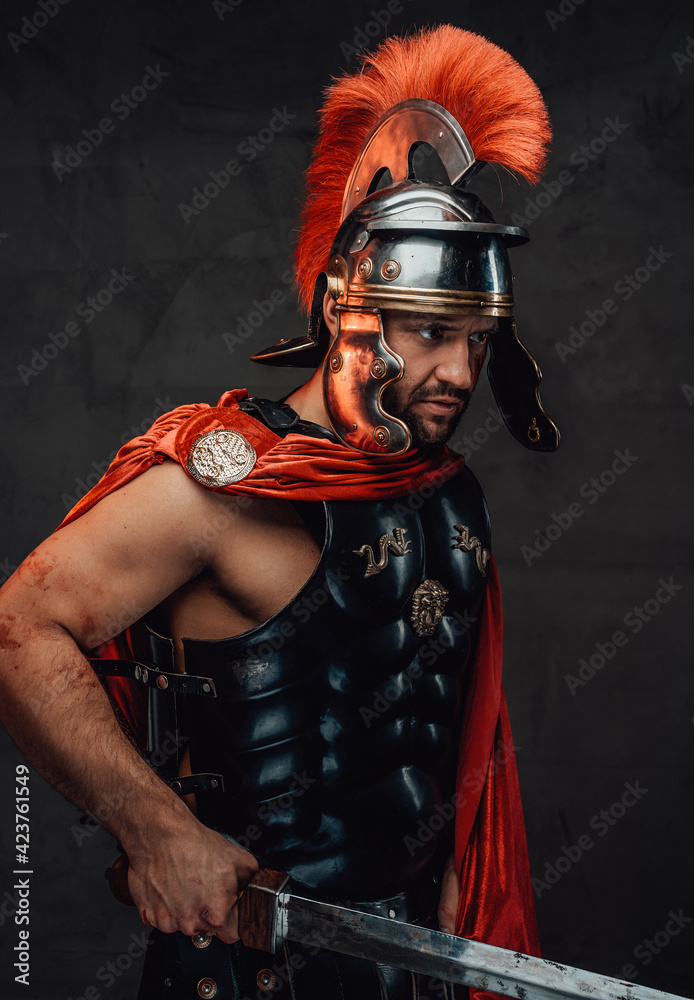 Roman soldier with red mantle and armour posing with sword Stock Photo ...