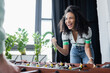 © LIGHTFIELD STUDIOS - excited african american businesswoman showing win gesture near table football, blurred foreground