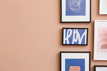 Poster - Stylish frames with pictures hanging on color wall