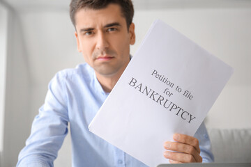 Sticker - Stressed man with petition to file for bankruptcy at home