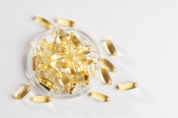 set of vitamin D, omega 3-6-9, zinc, yellow capsules on a white background