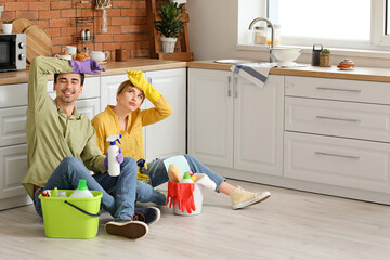 Poster - Couple resting after cleaning kitchen