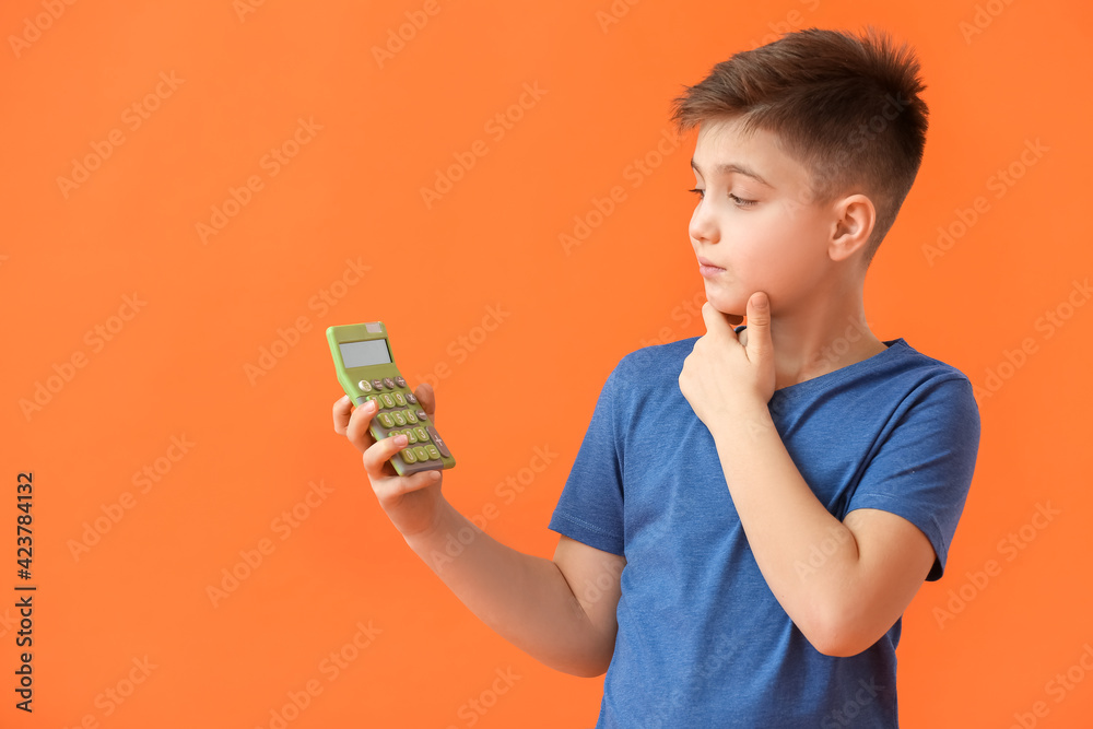 Little boy with calculator on color background