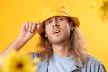 Sticker - Portrait of handsome young man and flowers on color background