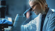© Gorodenkoff - Close Up Portrait of a Medical Research Scientist Conducting DNA Experiments Under a Microscope in a Biological Applied Science Laboratory. Beautiful Female Lab Engineer in White Coat.