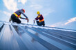 © tong2530 - Selective focus roof, construction worker safety wear using electric drill tools install on new roof metal sheet, Roof construction concept.