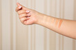 Female hand with swatches of makeup foundation