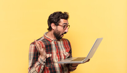 Poster - young crazy bearded man surprised expression and a laptop