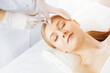© Iryna - Beautician doctor doing beauty procedure with syringe to caucasian female face. Cosmetic medicine and surgery, beauty injections concept