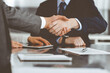 © Iryna - Handshake as successful negotiation ending, close-up. Unknown business people shaking hands after contract signing in modern office