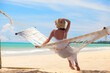© el.rudakova - Woman relaxing on hammock with straw hat sunbathing on vacation