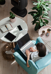 Young woman using laptop to work home, remote work