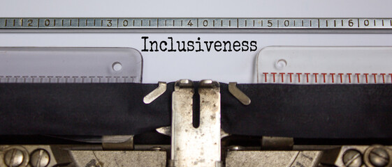 Inclusiveness and belonging symbol. The word 'inclusiveness' typed on retro typewriter. Business, inclusiveness and belonging concept. Beautiful white background.